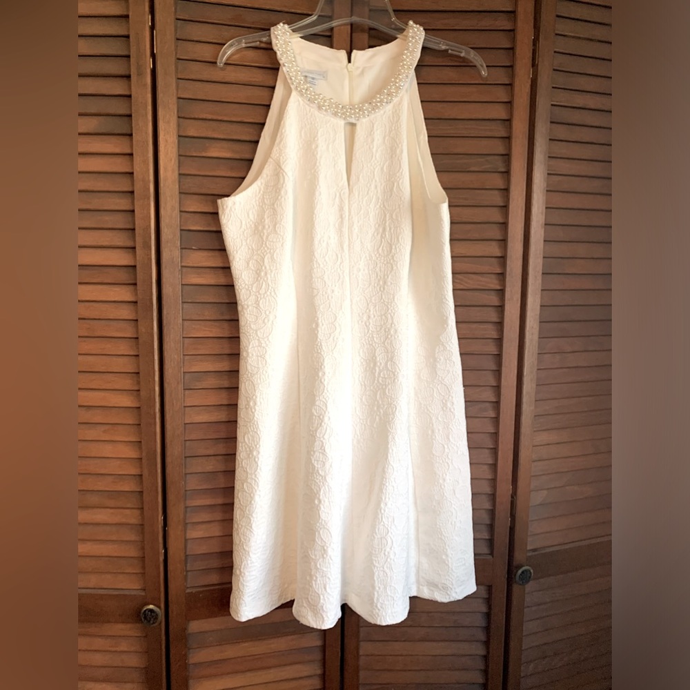 London Times white dress. Beaded neckline, peekaboo opening.